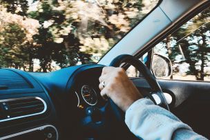 Person Holding Black Vehicle Steering Wheel